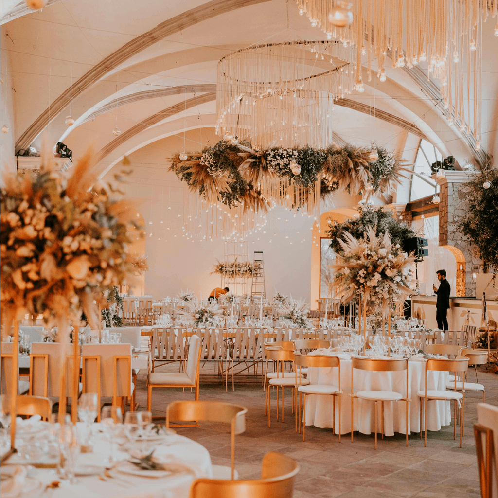 Elegant wedding reception with floral decor and warm lighting.