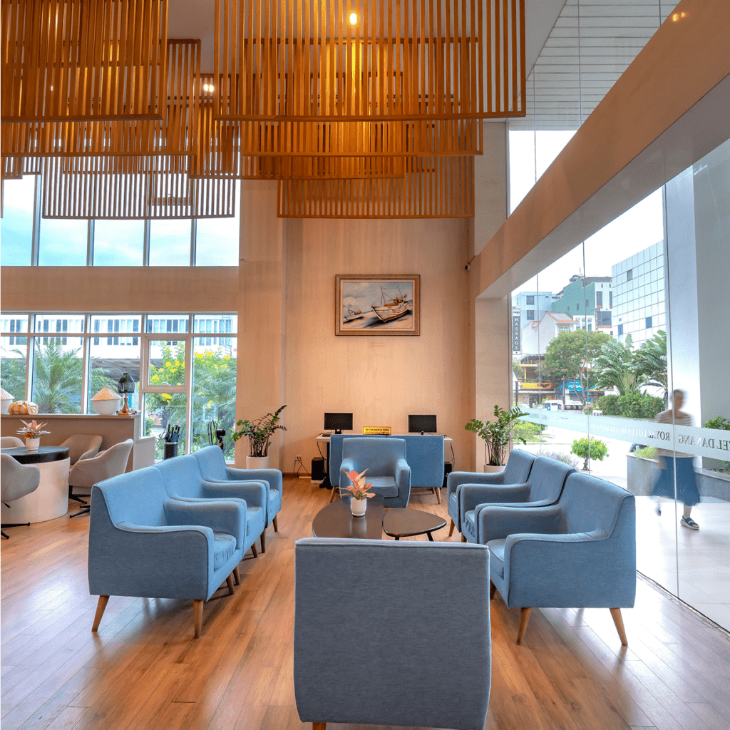 Modern lounge with blue chairs and wooden accents, bright and inviting.