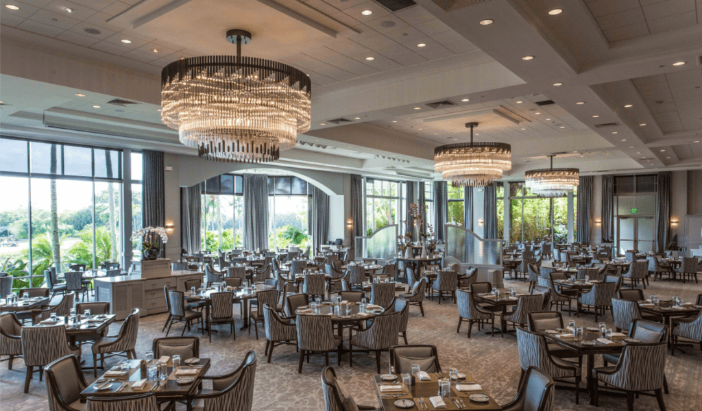 Elegant banquet hall with chandeliers and neatly arranged tables.