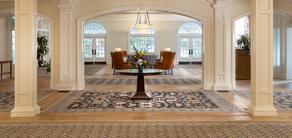 Elegant foyer with floral centerpiece and chandelier.